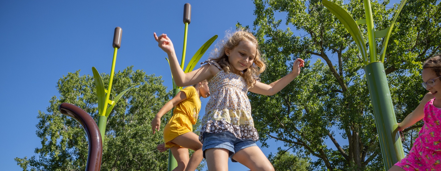 Girl playing on Nature-Inspired playground in Bay City, Michigan