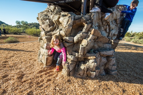 A GFRC rock-climbing structure with children playing