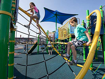 Children playing on helix-shaped rope climber